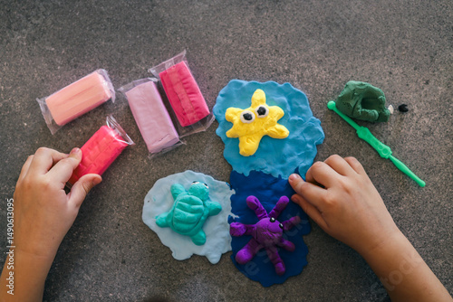 Canvastavla Children's hands sculpting sea animals like starfish, turtle, and octopus using