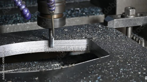 The CNC milling machine rough cutting the metal plate parts by solid flat nose end mill tool.