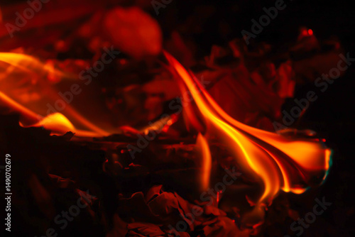 soft focus photo of beautiful fire flames with reflection on dark background.