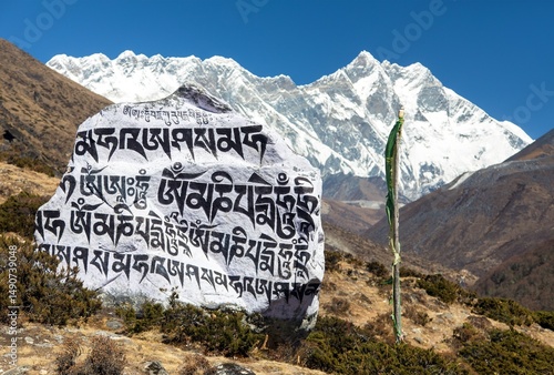 White stone with black buddhist symbols and Lnotse peak