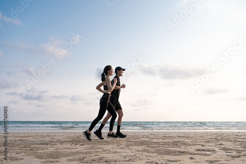 Young men and women run along the sea or beach to promote health, strength and quality of life, emphasizing the concept of fitness, sports and having a healthy lifestyle for both young and old people.