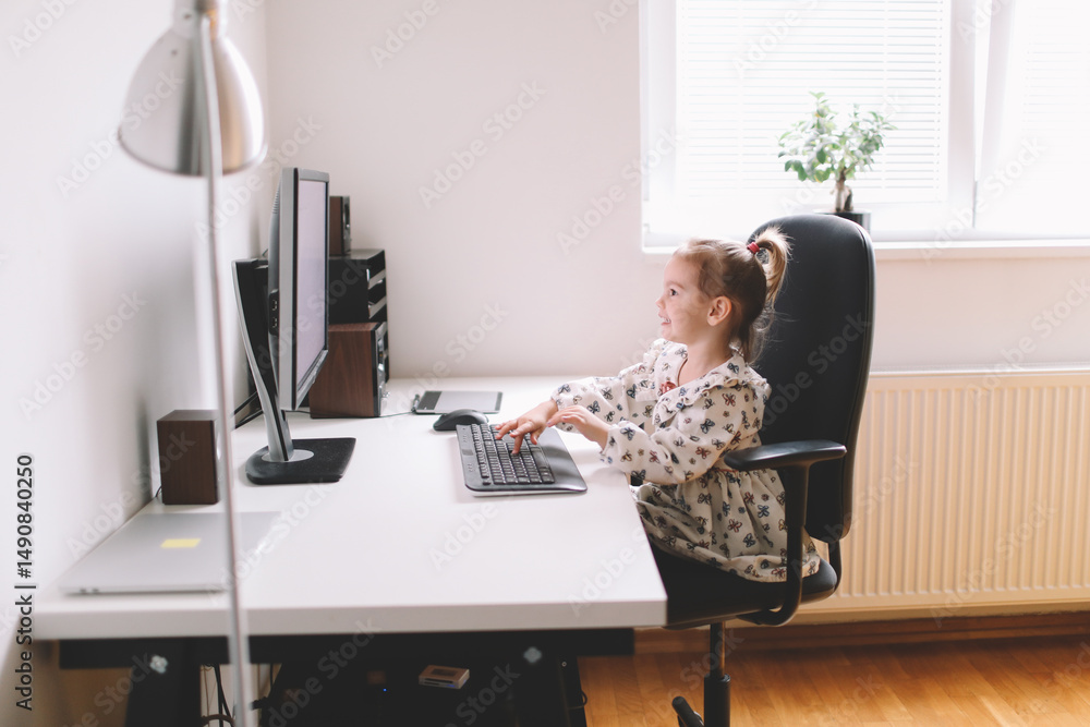 Little girl typing on computer Little girl typing on computer