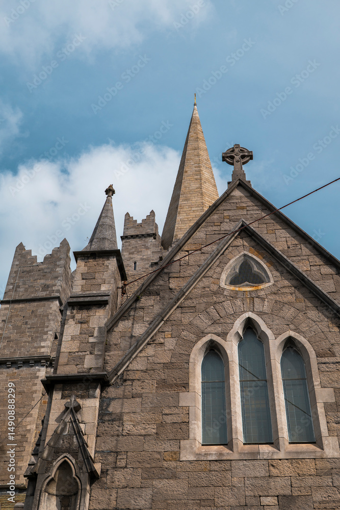 Fototapeta premium St Patrick’s Cathedral, the largest cathedral in Ireland, stands as a majestic symbol of Dublin’s spiritual and architectural heritage. With its soaring Gothic spires, intricate stained glass windows,