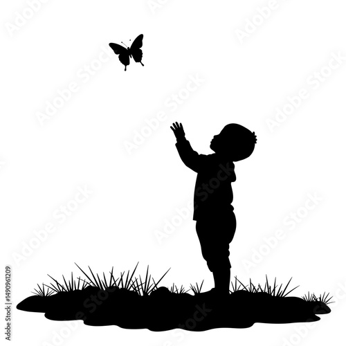 Silhouette of child reaching for butterfly in grassy field  