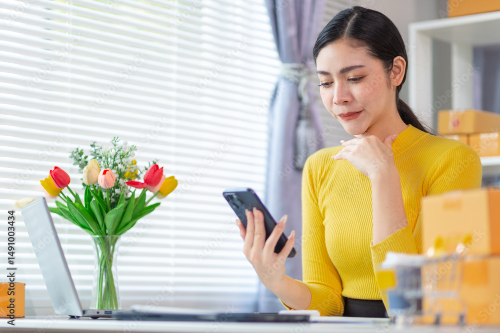 businesswoman creates home office to receive orders from customers via a mobile phone application and uses her mobile phone to contact customers and confirm orders before shipping them. copy space businesswoman creates home office to receive orders from customers via a mobile phone application and uses her mobile phone to contact customers and confirm orders before shipping them. copy space
