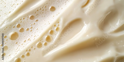 Close-up of creamy white bubbly liquid with smooth flowing texture.