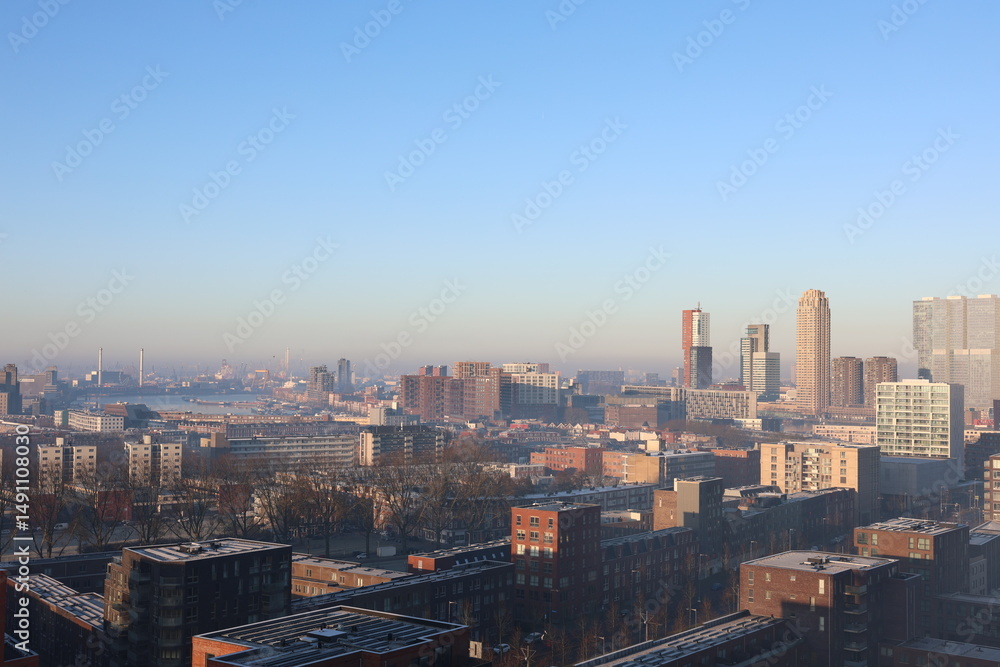 Fototapeta premium A misty landscape photo with the Nieuwe Maas River in Rotterdam, the Netherlands, in the background.