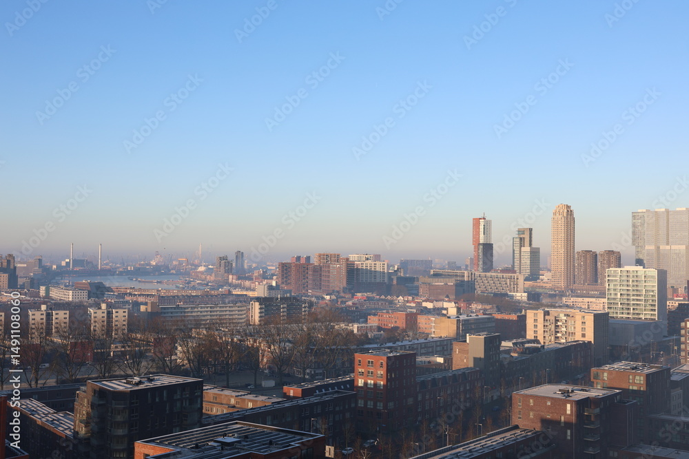 Fototapeta premium A misty landscape photo with the Nieuwe Maas River in Rotterdam, the Netherlands, in the background.