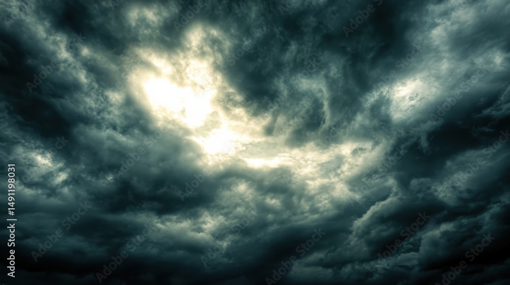 Fototapeta premium Dark and Dramatic Storm Clouds with Bright Light Breaking Through