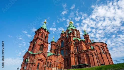 Uspenski cathedral in Helsinki Finland hyper lapse - time lapse of Christian Orthodox religion church made of red brick showcasing magnificent architecture. Historical temple in setting sun light.