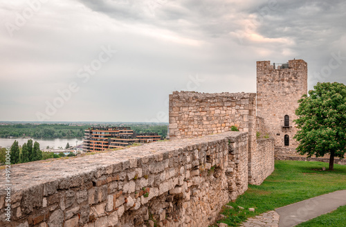 The walls and the ramparts of upper town of the Belgrade Fortress. The modern city of Belgrade and the confluence of the Sava and Danube rivers are in the background.