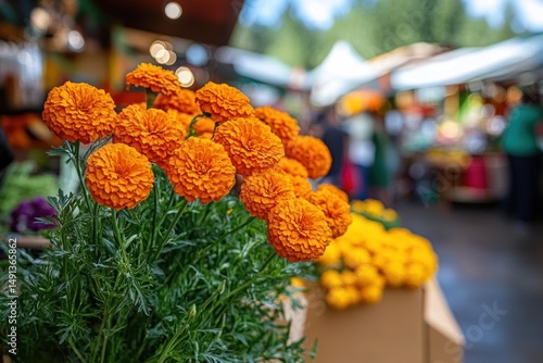 Bright orange marigold flowers in full bloom at an outdoor market stall with blurred background of people and greenery