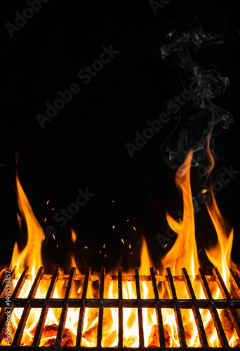 close up view of a metal grill with intense orange flames and rising sparks