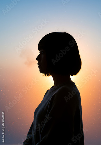 Serene Silhouette of Woman with Short Hair Against Sunset Sky