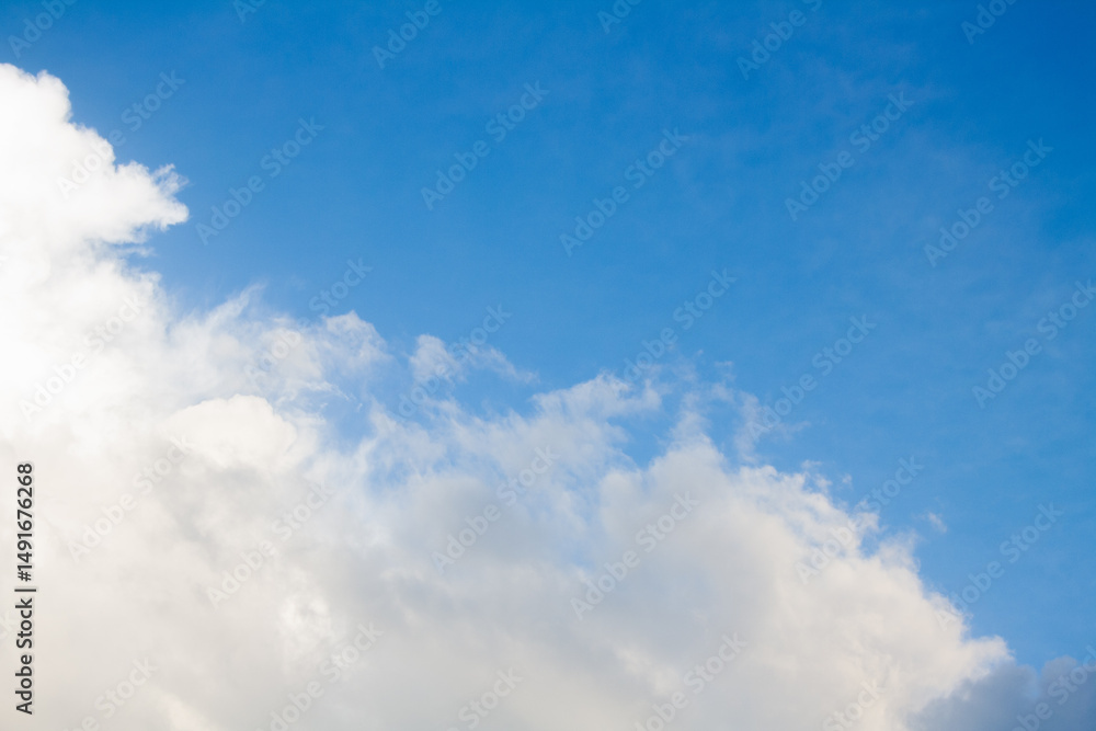 Naklejka premium Blue sky with soft white clouds for background