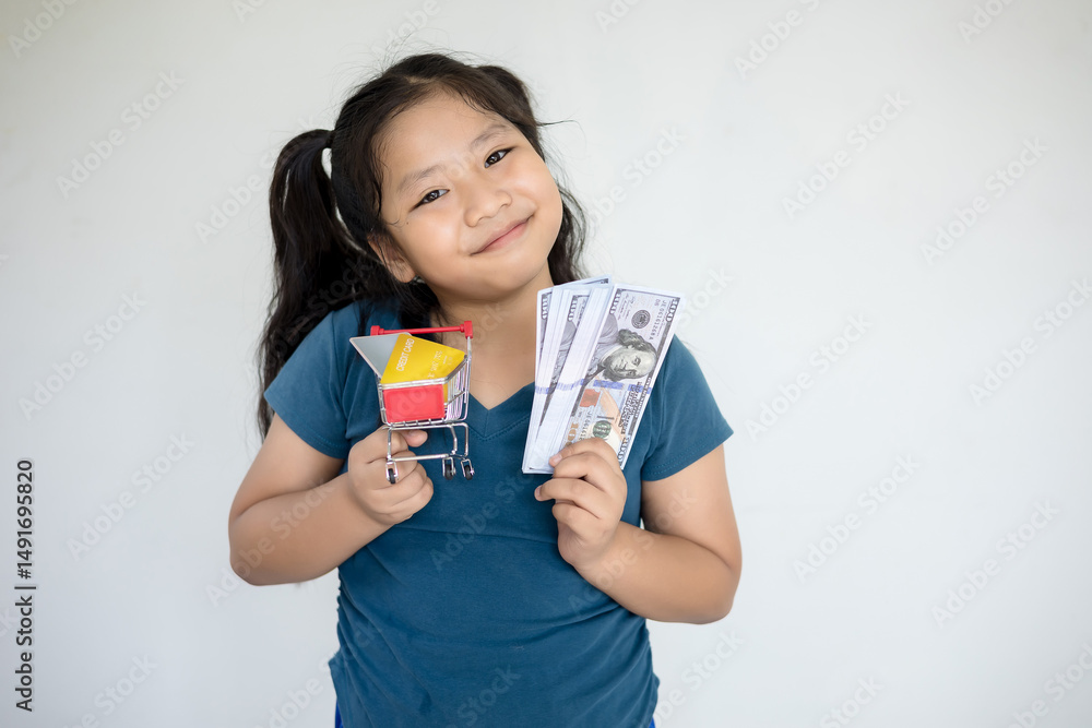 Woman holding cash and small shopping cart with credit card inside on white background Woman holding cash and small shopping cart with credit card inside on white background