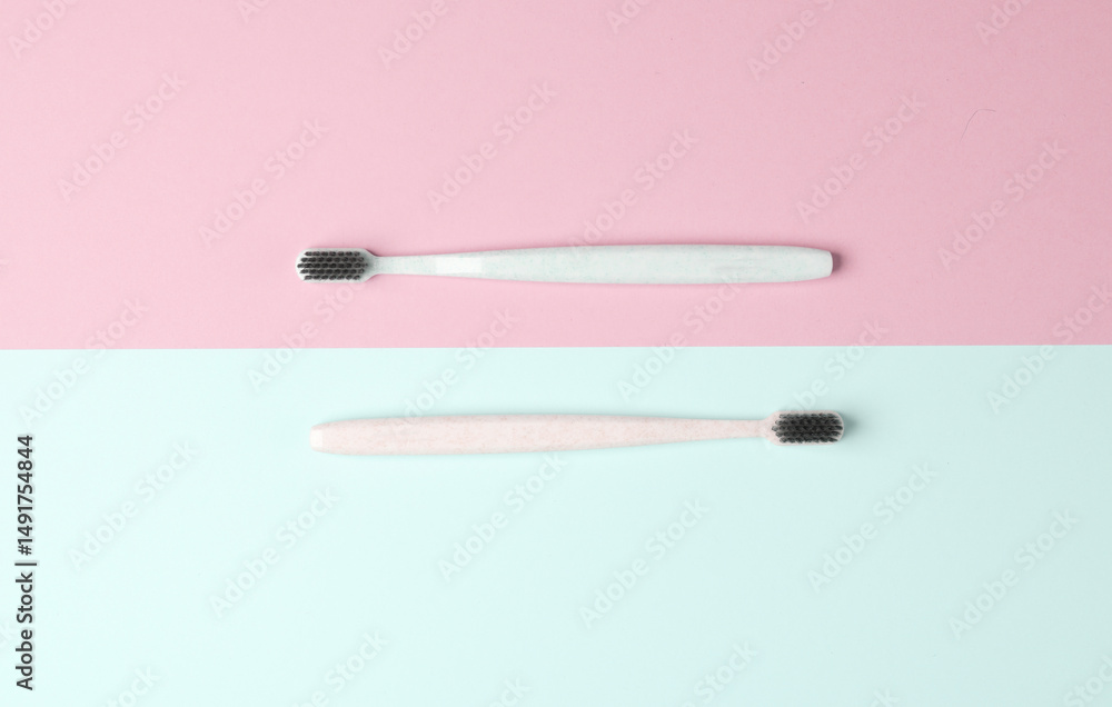 Two plastic toothbrushes on a pastel background. Oral hygiene Two plastic toothbrushes on a pastel background. Oral hygiene