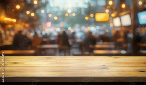 Wallpaper Mural Empty wooden table in a warmly lit busy cafe or restaurant with blurred people and glowing lights in the background creating a cozy atmosphere Torontodigital.ca