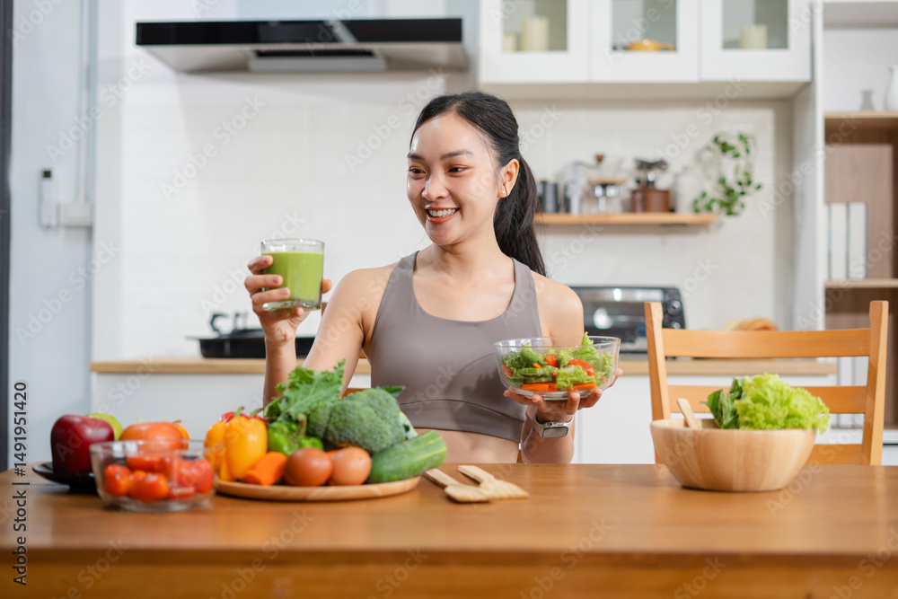 Fit woman enjoys healthy fresh vegetables and fruits breakfast sitting in the kitchen. Fit woman enjoys healthy fresh vegetables and fruits breakfast sitting in the kitchen.