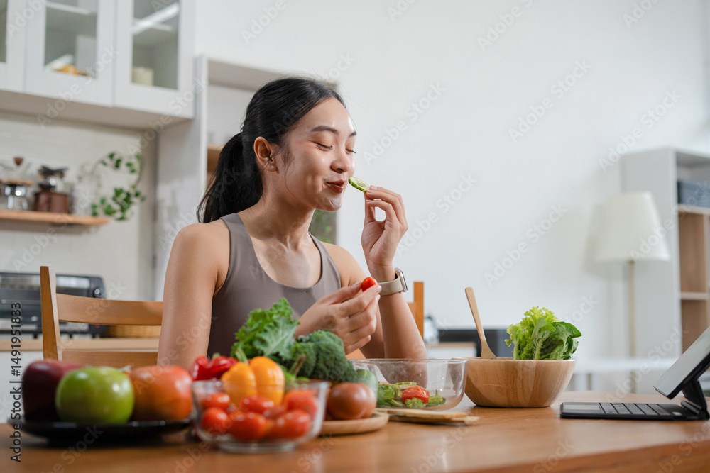 Fit woman enjoys healthy fresh vegetables and fruits breakfast sitting in the kitchen. Fit woman enjoys healthy fresh vegetables and fruits breakfast sitting in the kitchen.