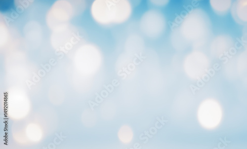 Blurred abstract background with bokeh lights in blue and white colors.