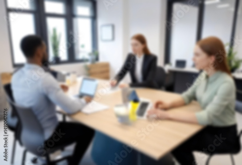 having a meeting in a blurry office, the atmosphere of a group of people having a meeting in a natural-themed, modern office with a wooden table, with a blurry office background
