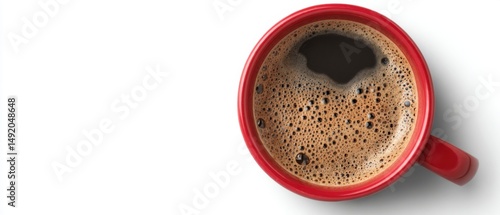 Overhead shot of fresh brewed coffee in a red mug on a white background showing rich foam and dark liquid