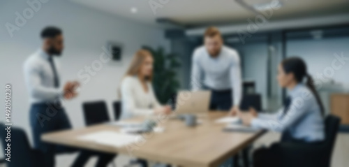 having a meeting in a blurry office, the atmosphere of a group of people having a meeting in a natural-themed, modern office with a wooden table, with a blurry office background