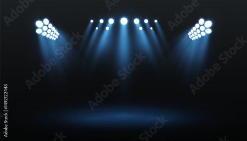 Realistic stage lighting with bright blue spotlights beaming into darkness. Glowing rays create a dramatic concert or theater scene for backgrounds, banners, posters, and performances.

