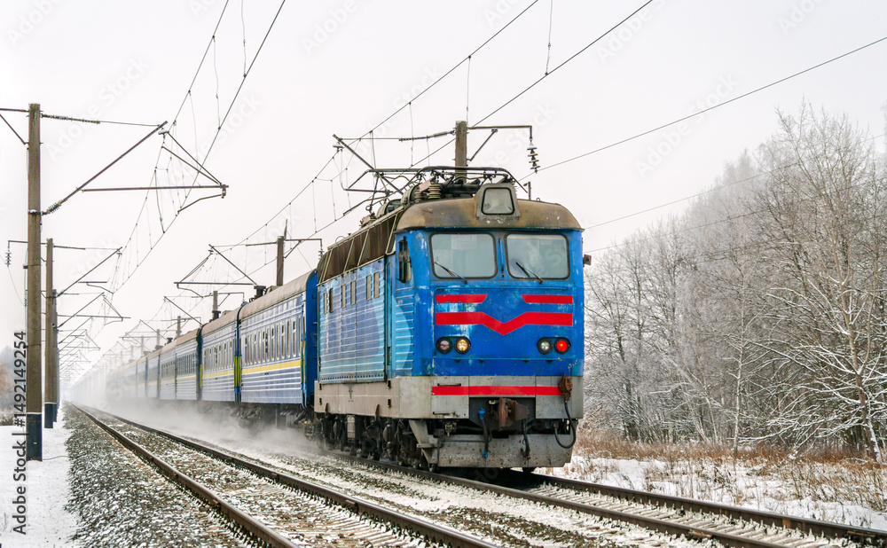 Passenger train hauled by an electric locomotive in winter in Chernihiv Oblast of Ukraine Passenger train hauled by an electric locomotive in winter in Chernihiv Oblast of Ukraine