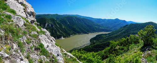 Fotografie Panoramic view of the danube river winding through lush green hills from a rocky