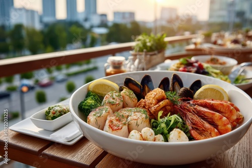 Delicious seafood platter served on a vibrant restaurant terrace during sunset in a bustling city