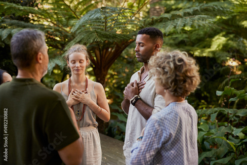 People meditating at holistic retreat with hands on heart