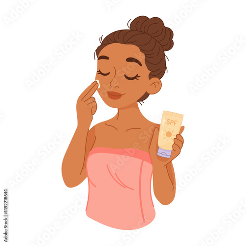 Dark-skinned woman applying SPF sunscreen to her face