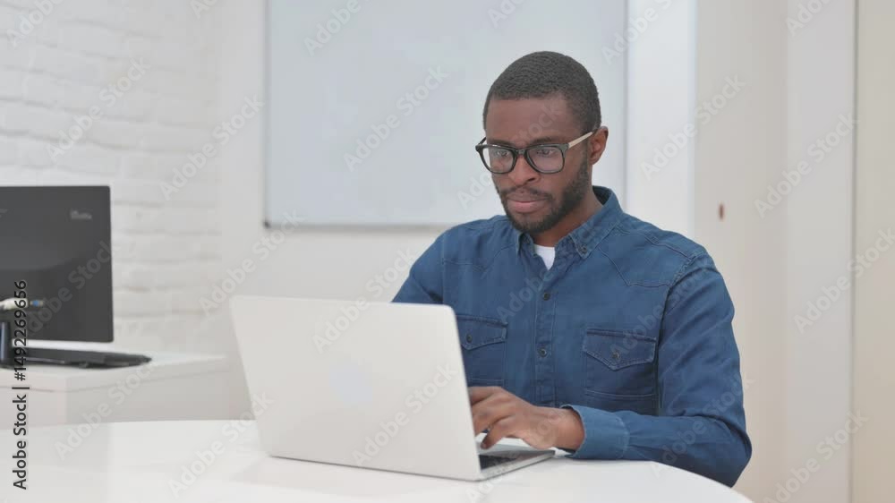 Middle Aged African Man Typing on Laptop Middle Aged African Man Typing on Laptop