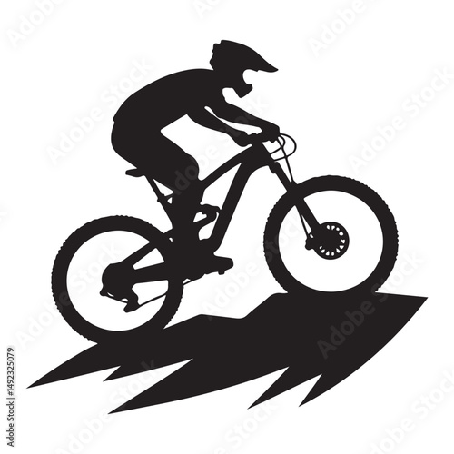 Mountain biker silhouette riding uphill challenging off road trails