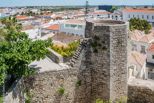 Wall and octagonal albarrã tower of the castle and architecture of Tavira, PORTUGAL