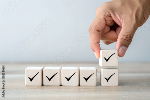 Checklist and task progress tracking concept. A hand placing the final checkmark on wooden blocks in a progress bar, task completion, productivity, goal setting, and efficient project management.