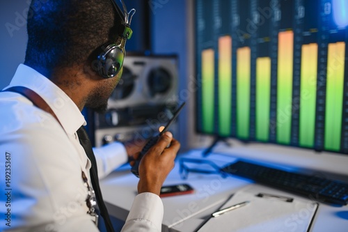 Secret agent listens on the reel tape recorder. Officer wiretapping in headphones