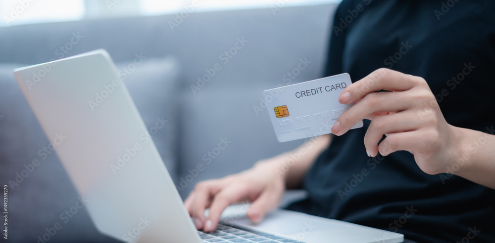 Woman holding credit card, paying with credit card, with laptop, online shopping concept Woman holding credit card, paying with credit card, with laptop, online shopping concept