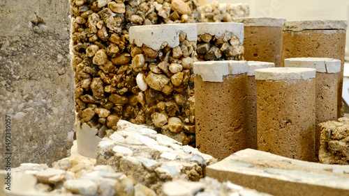 Close-up of experimental building materials combining gravel, clay, and cement—earthy texture composition for sustainable architecture, eco-construction inspiration, and raw material design showcase