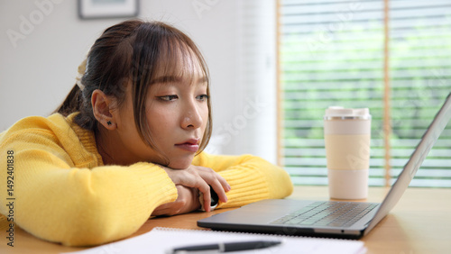 Asia people young woman study hard brownout bored remote work coding online read data tired sitting lying down at home desk think worry in career job tough stress workforce mental health issue illness