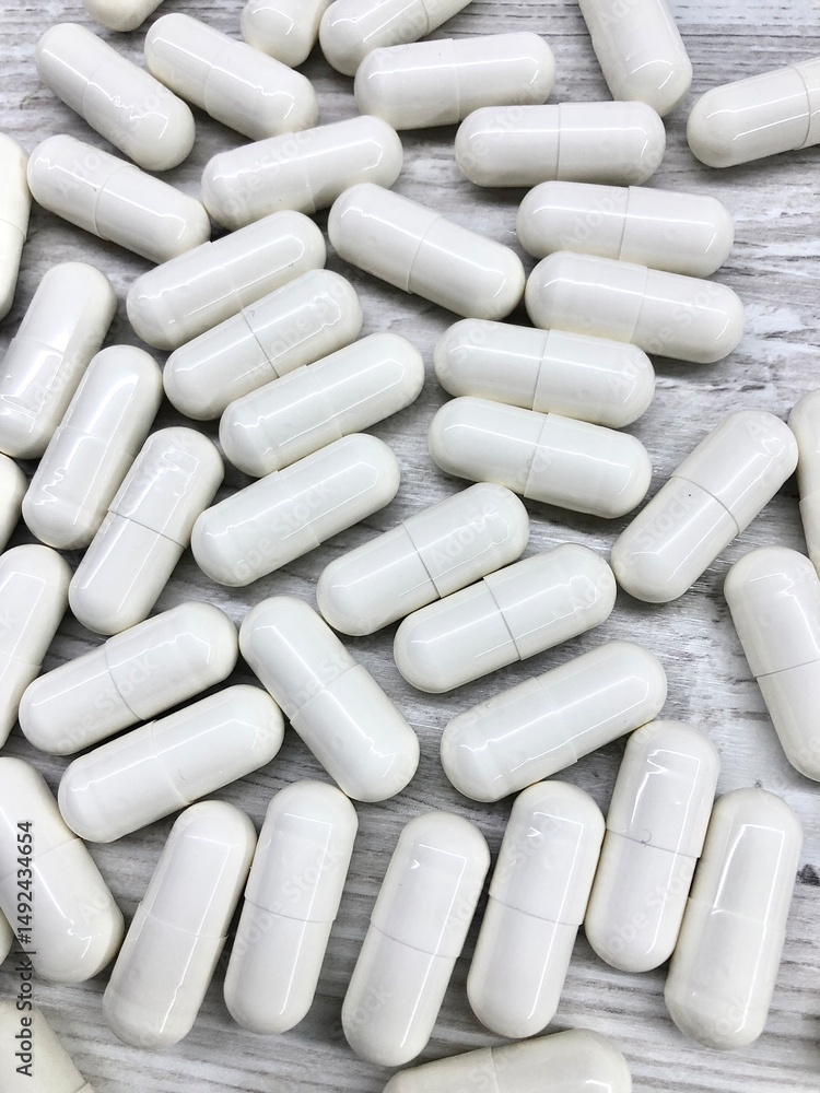 close up photo white capsules with medications or amino acids or creatine close up photo white capsules with medications or amino acids or creatine