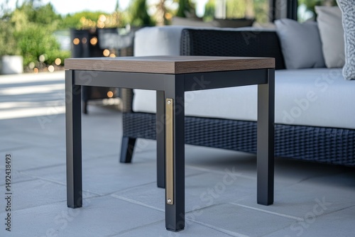 Modern outdoor side table with dark accents.