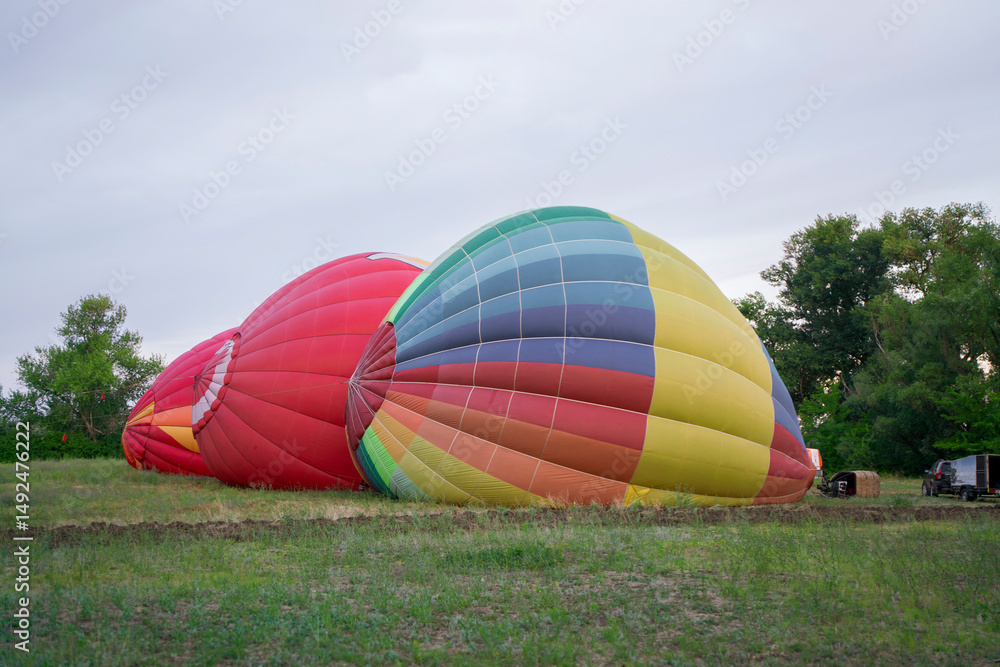 Obraz premium Colorful aerostat balloons are being inflated on the ground