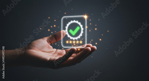 Persons hand holding a glowing green checkmark with five gold stars.