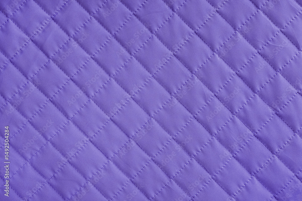 Fototapeta premium Checkered, diamond stitching pattern, purple quilted fabric background. Blanket or puffer jacket, stitch rhombus texture close up, macro. Wallpaper, backdrop.
