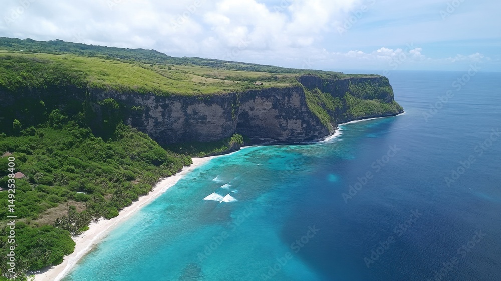 Fototapeta premium Aerial view of light blue ocean with soft waves crashing into an untouched coastline