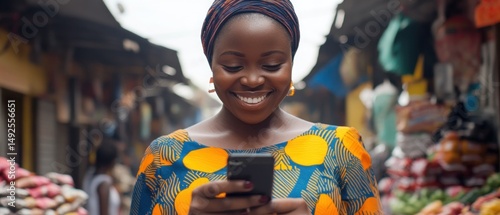 Obraz na płótnie African woman using mobile phone in a market w salonie