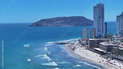 Aerial Mexico Mazatlan city sandy beach. Commercial ocean vacation tourism seaport, cargo and cruise ships. Luxury resort Mexican Riviera. Romantic destination. Sand, surf and beach recreation travel.